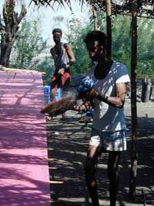 Working in the shade, the size is flicked carefully all along the length of the warp threads.