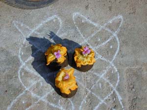 This special Pongal offering is made from cow dung and fresh flowers on a traditional kolam design.