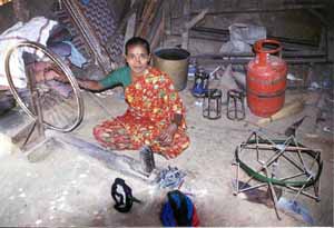 Balaji's mother helps out winding bobbins.