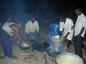 Anandan prepares 'vadai' for his guests as part of his housewarming celebrations.