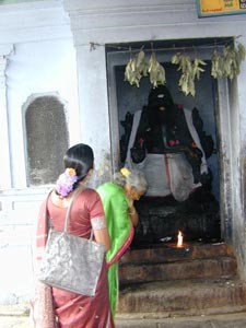Selvi and Sorja Amma offer prayers to Lord Ganesha on the way to Tiraputi Temple in Andra Pradesh.