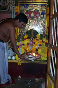 A priest makes an offering to the gods in a local temple.