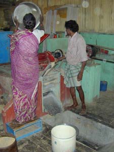 Villagers take brown rice to the local mill to have it polished.