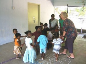 Sally Whittingham teaches the children the Hokey Cokey.
